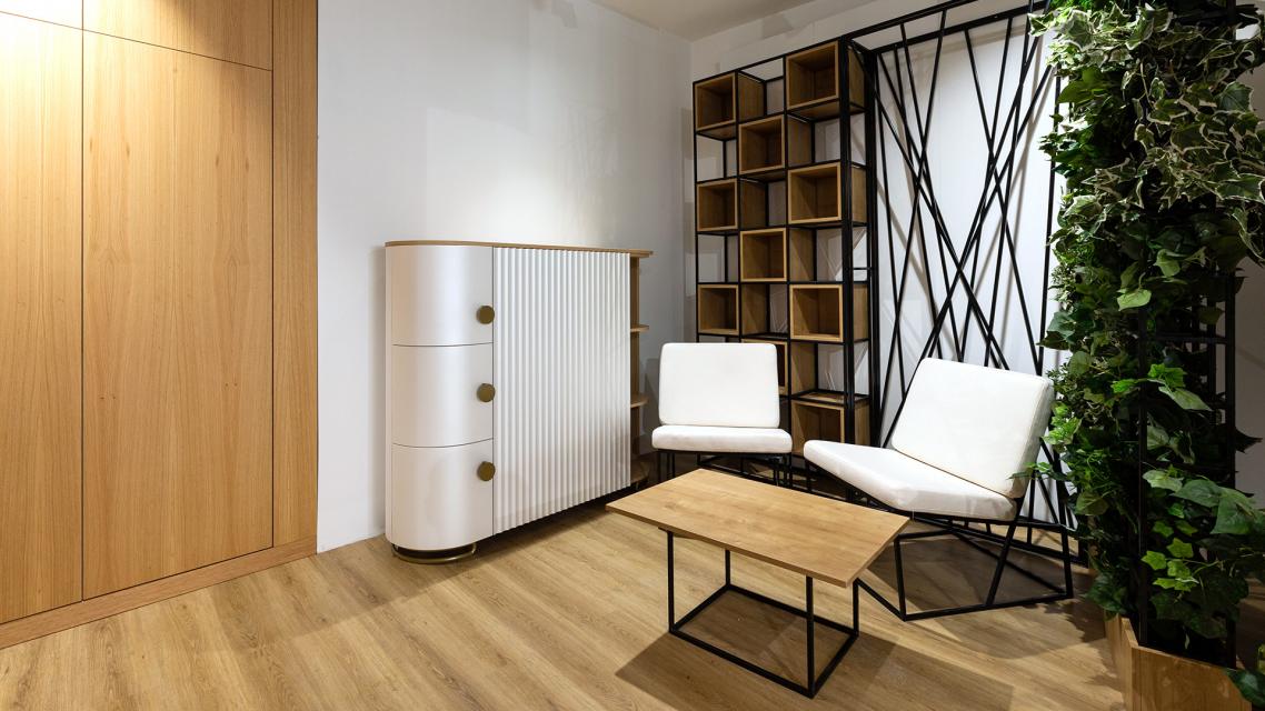 Modern belsőépítészeti enteriőr T-DESIGN komóddal és LOFT bútorokkal Ez a letisztult, modern enteriőr jól szemlélteti, hogyan illeszkedik a T-DESIGN egyedi tervezésű komódja egy kortárs belső térbe. A finoman mart, íves frontfelületek, a tölgyfa részletek és a visszafogott színvilág elegáns megjelenést kölcsönöznek a bútornak, miközben praktikus tárolási megoldást biztosít. A komódot a TorTer LOFT bútorcsalád elemei egészítik ki: a karakteres acélvázas lounge fotelek, a minimalista dohányzóasztal, valamint a nyitott térelválasztó polcrendszer harmonikus egységet alkotnak.