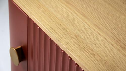 This detail shot highlights one of the defining characteristics of the T-DESIGN collection: the harmonious combination of materials and textures. The warm grain of the natural oak top beautifully complements the copper-blush, finely milled front, giving the piece a distinctive yet understated appearance.  The precisely crafted fluted pattern, custom metal handle, and carefully selected color palette demonstrate that every detail is just as important as the overall design.